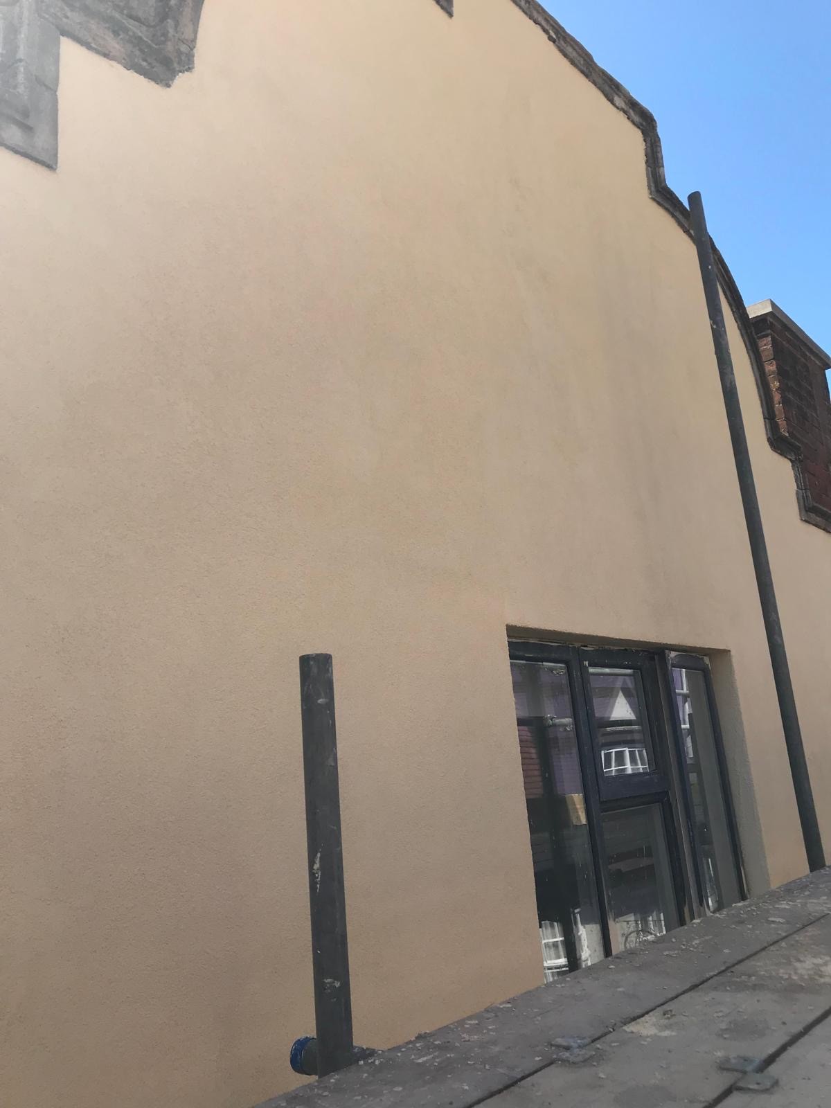 Close-up view of PPM Builders' commercial silicon render application on a Weatherspoons building in Northampton town. The smooth, durable finish enhances weather protection and aesthetic appeal.