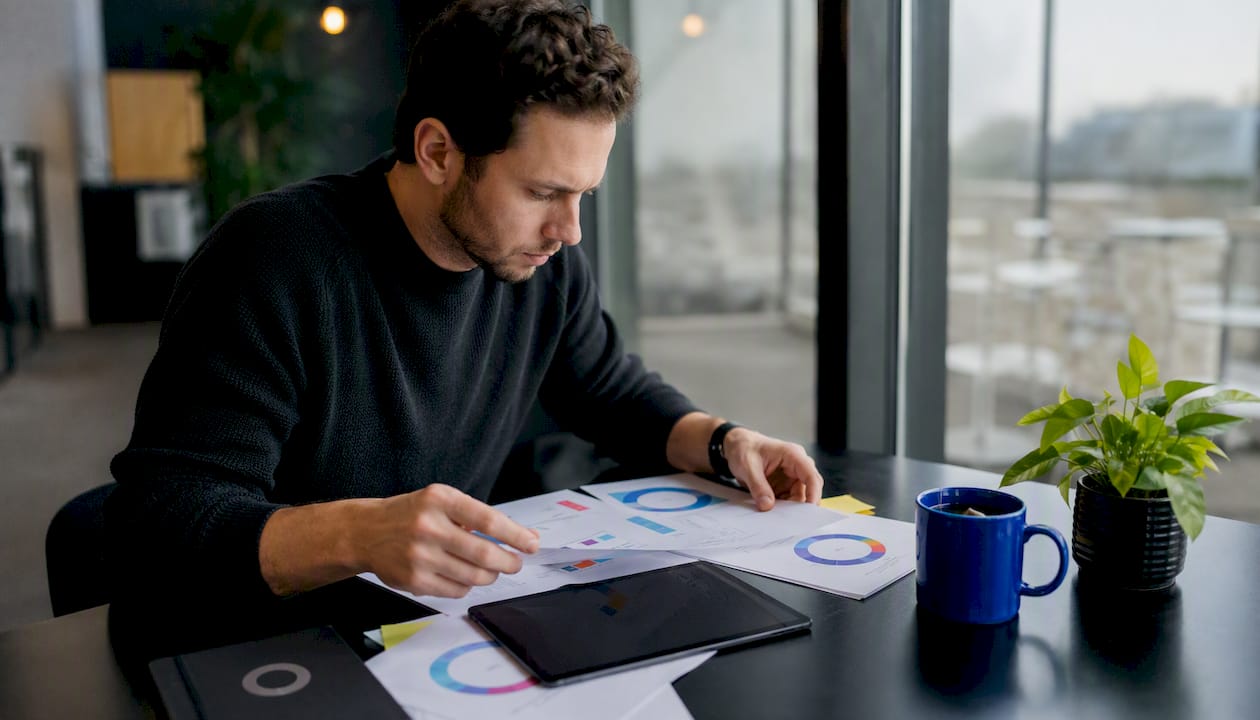 Hands with tablet and printed automation flowchart