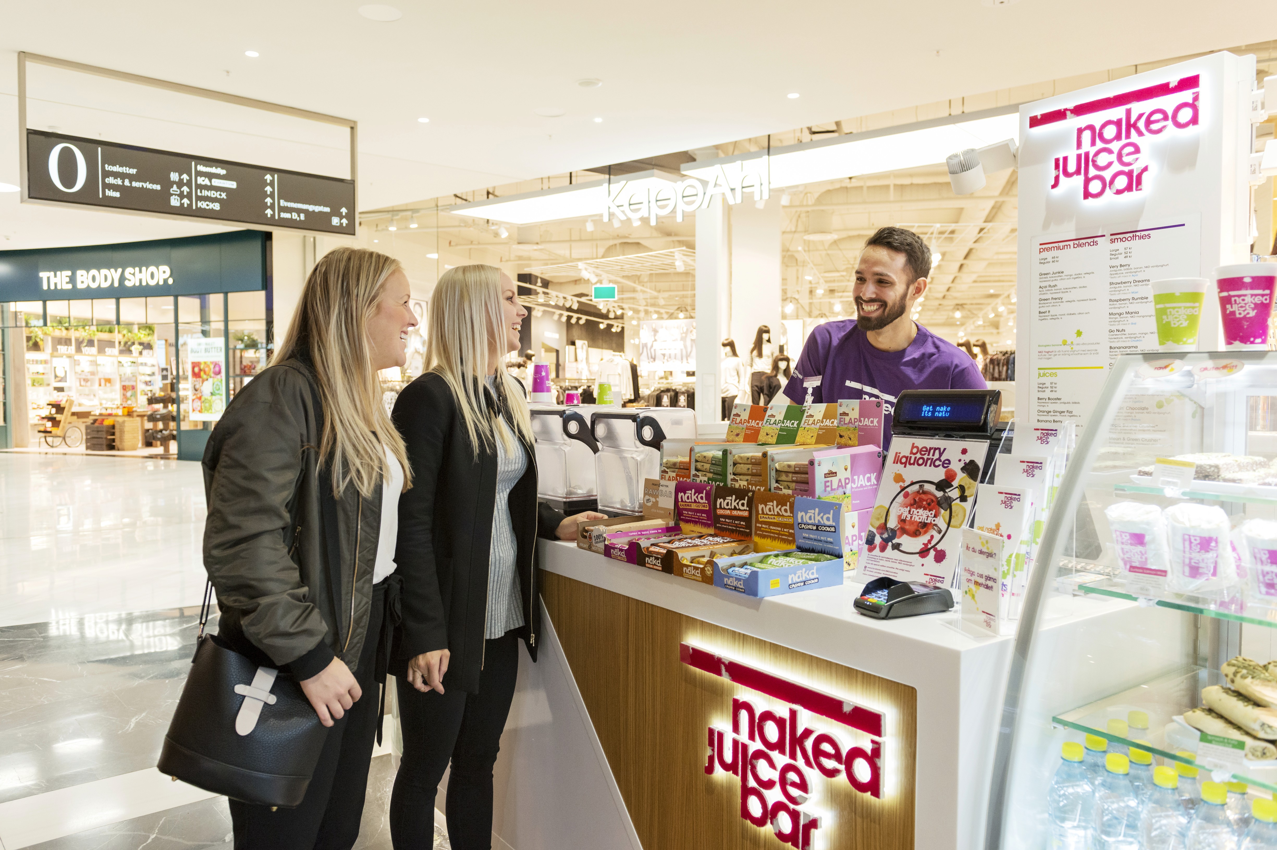 Picture of 2 women getting a juice at the naked juice bar
