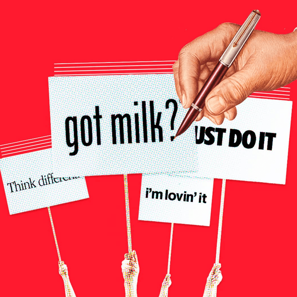 Mano sosteniendo bolígrafo sobre carteles publicitarios con eslóganes populares en fondo rojo.