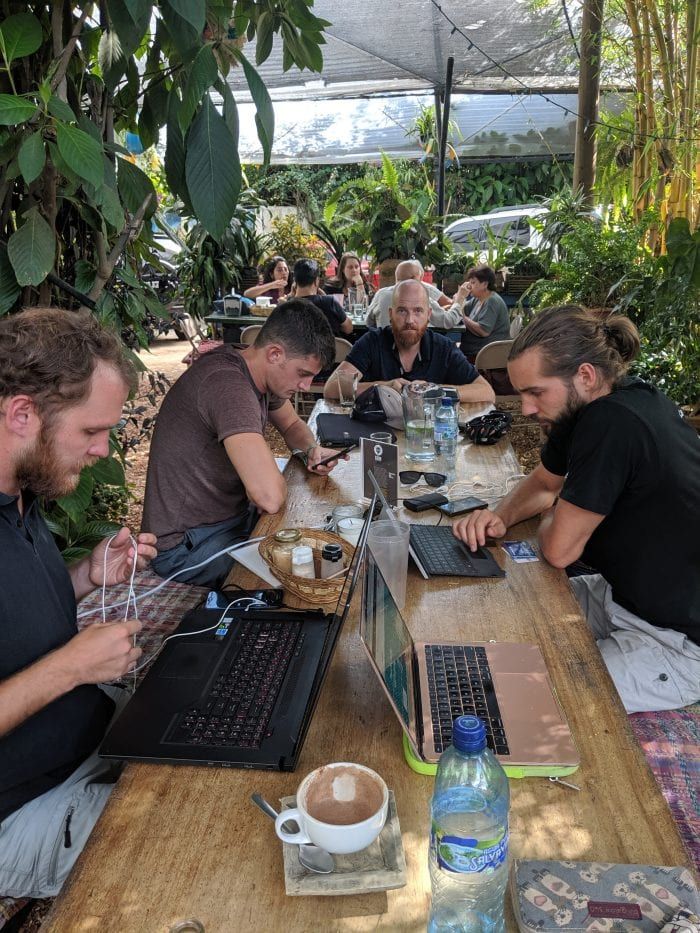 men sitting in front of their laptop computer