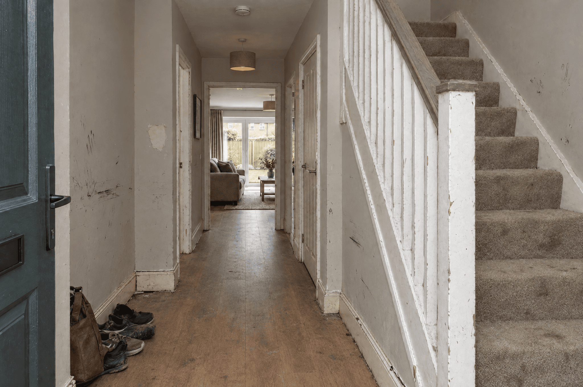 Scuffed hallway and stairs in a Westcombe new-build before decorating