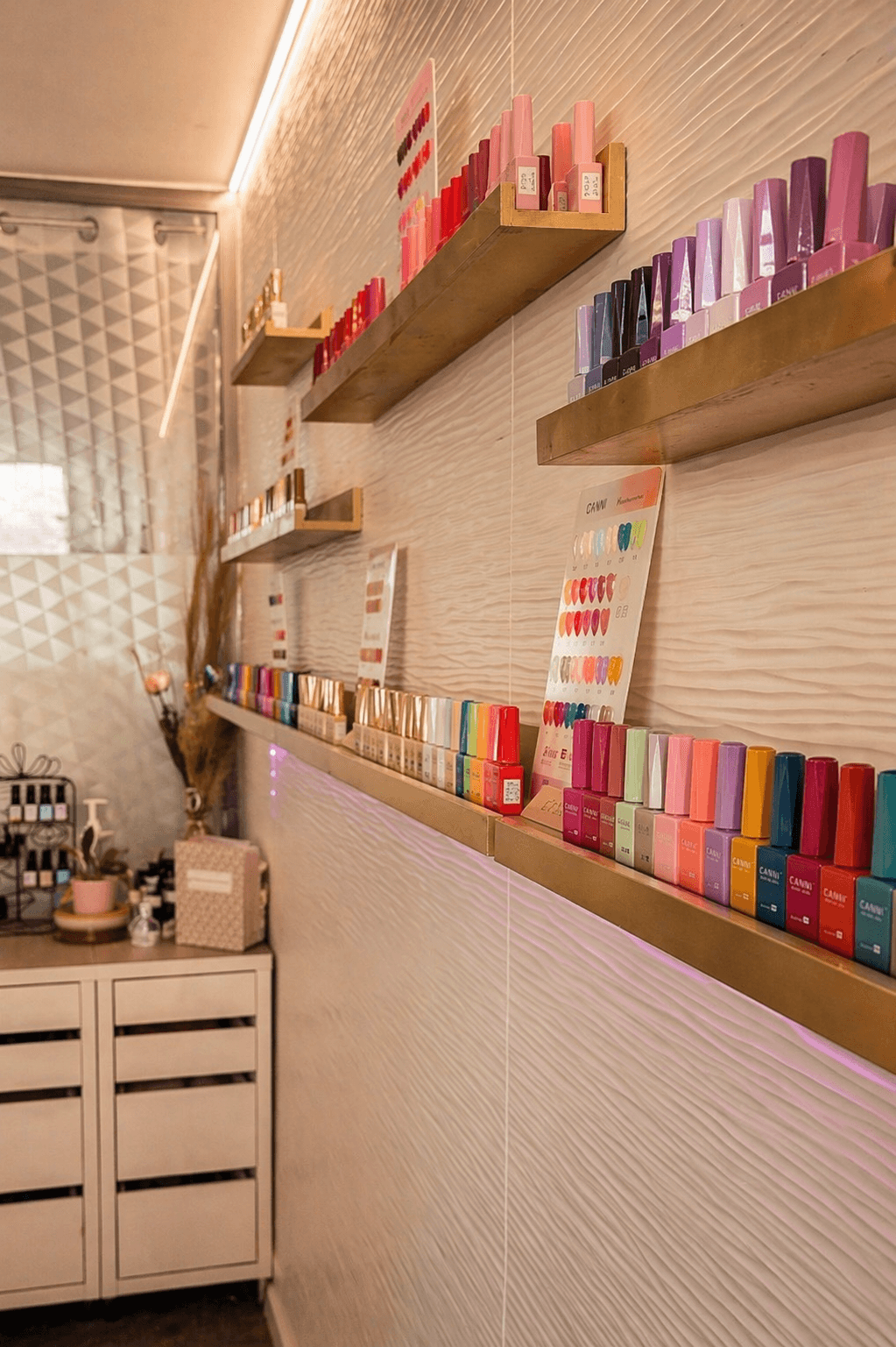 A rustic table set with various traditional pastries and a small bottle, surrounded by green foliage.