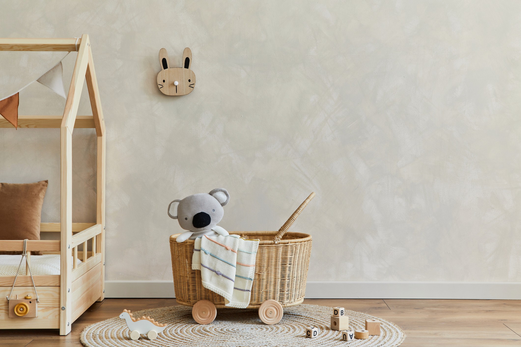 home nursery with stuffed koala bear and limewash plaster in background