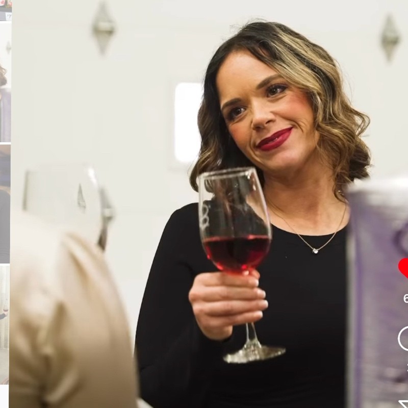 woman in black jacket standing near orange and white bus during daytime