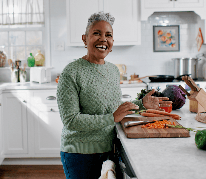 Woman laughing in her kitchen