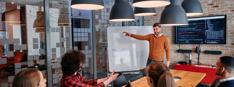 A team looking at a white board planning the data foundation for their company.