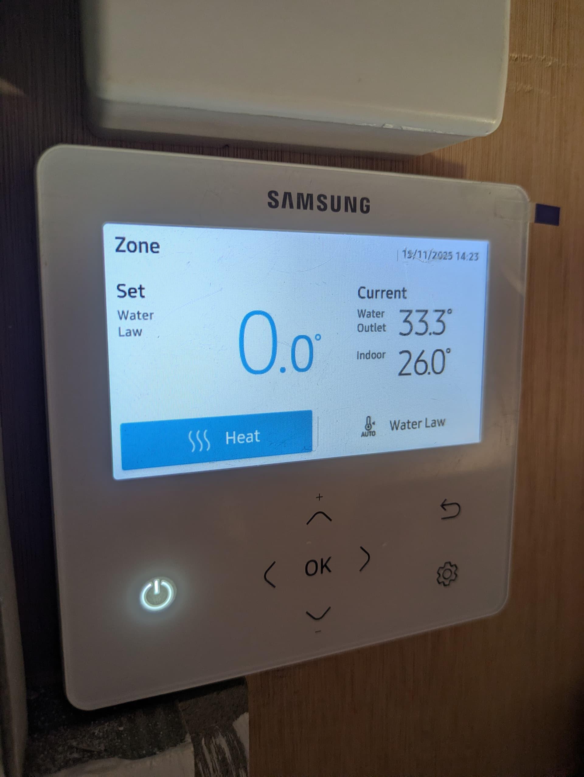 Air source heat pump outdoor unit outside a UK home showing signs of short cycling due to oversizing and poor system flow balance