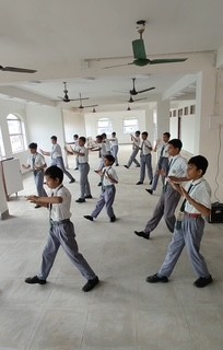 Students practising Ta Chi and movement activities