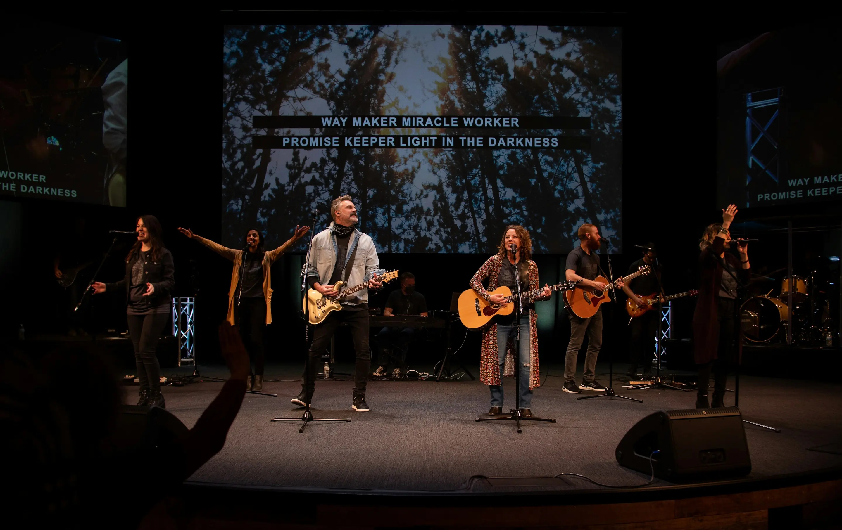 A worship band leading songs on stage
