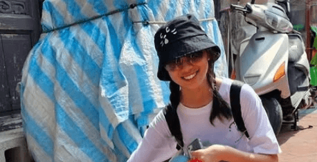 two people in a workspace working on their laptops