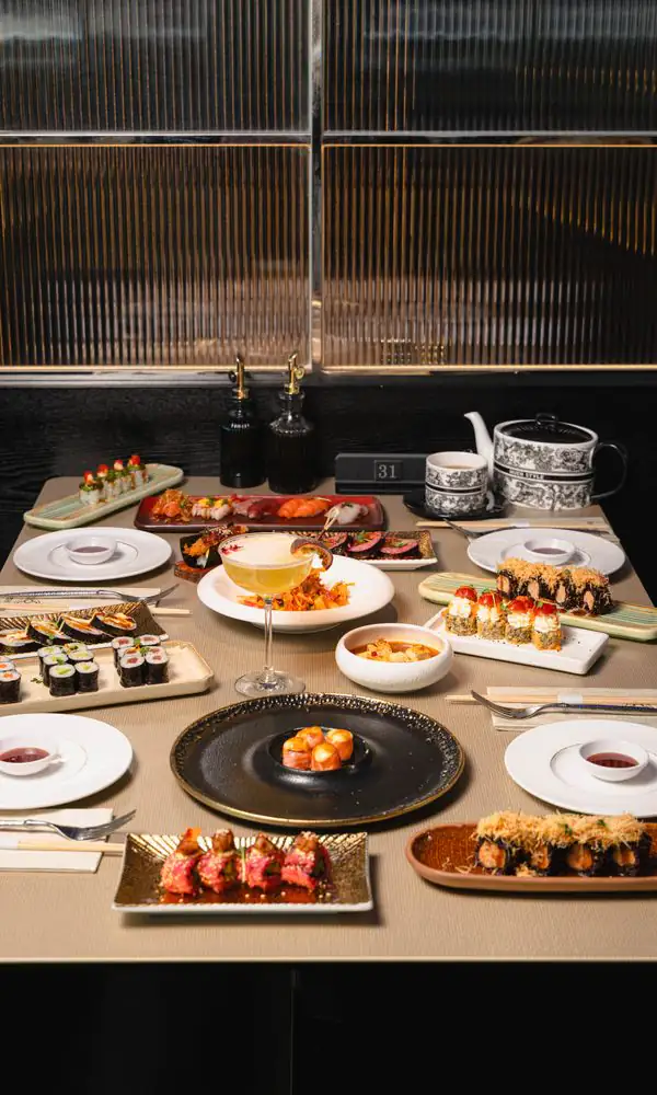 A table set behind brass-framed fluted-glass partitions