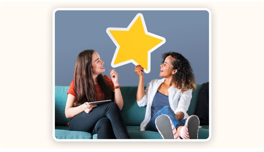 Two women holding yellow star