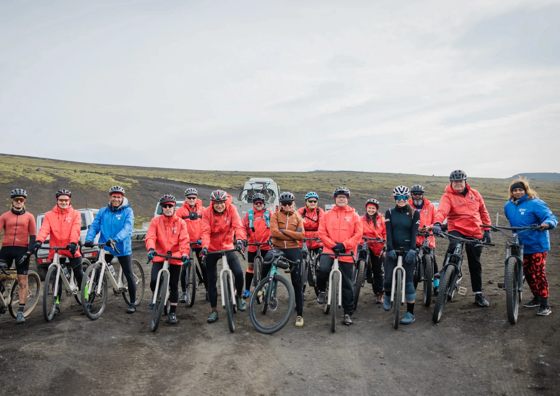 a group of cyclists on fundraising trip face camera before trip start 