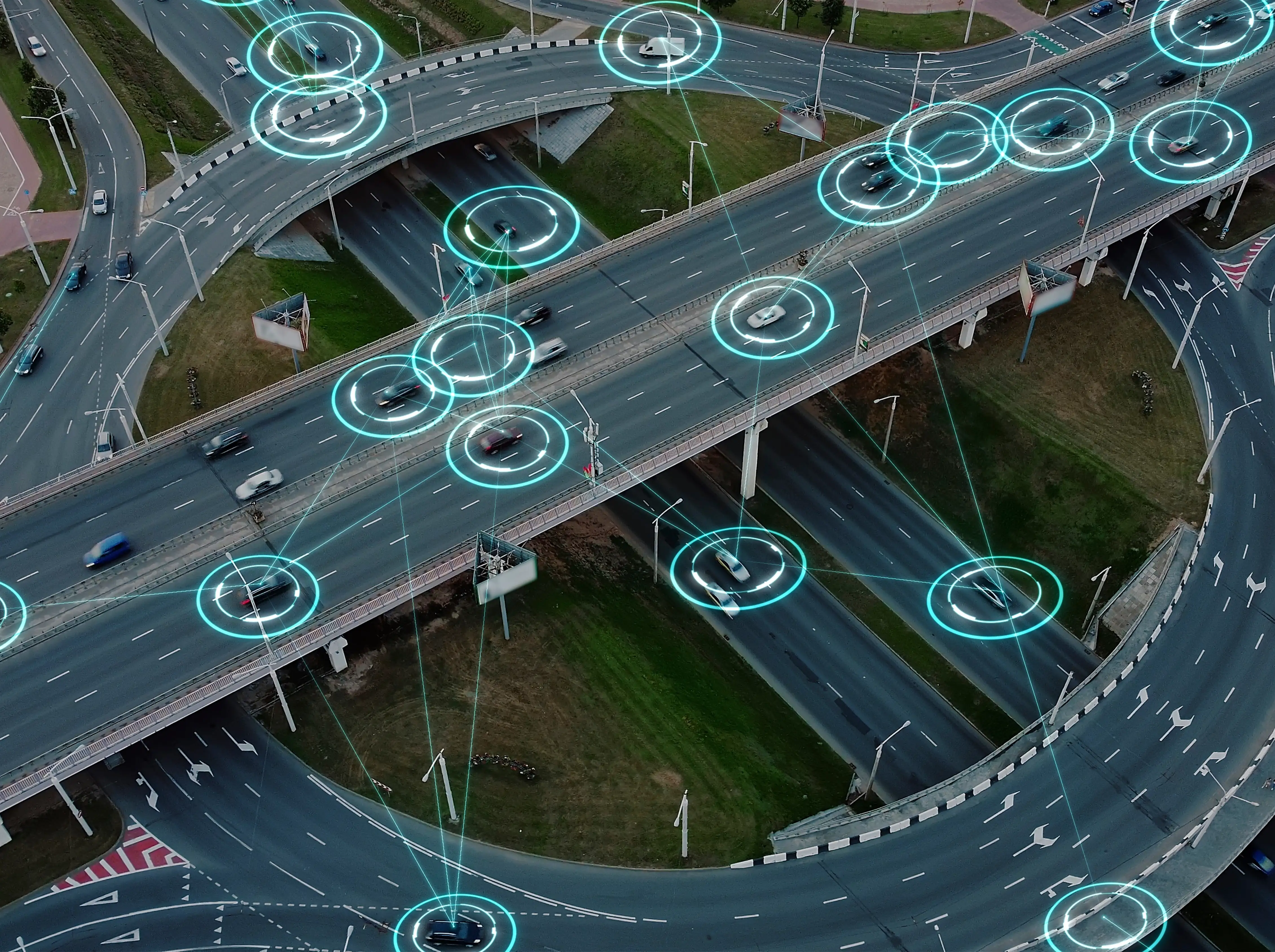Aerial view of highway interchange with digital overlay indicating connected vehicles