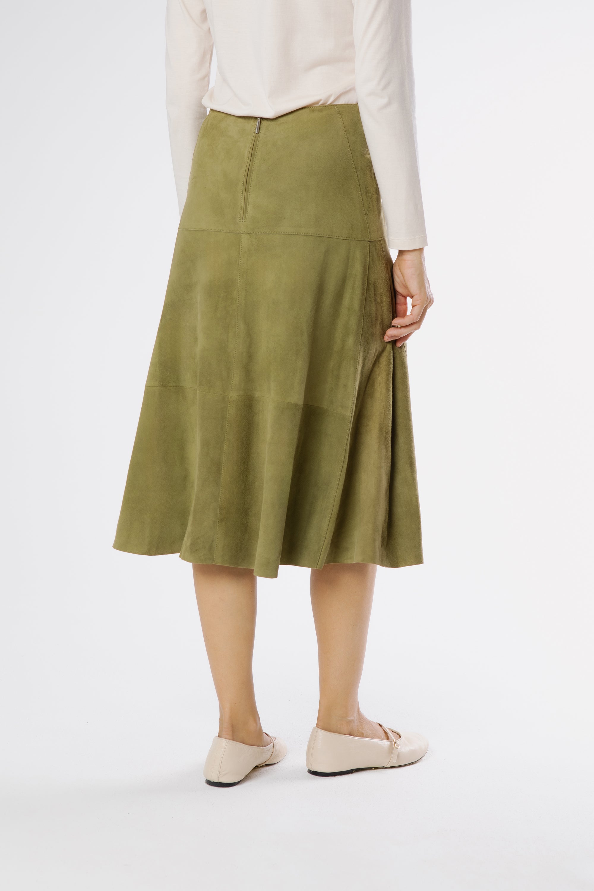 Back view of basil green suede midi skirt showing smooth suede surface and gentle flare.