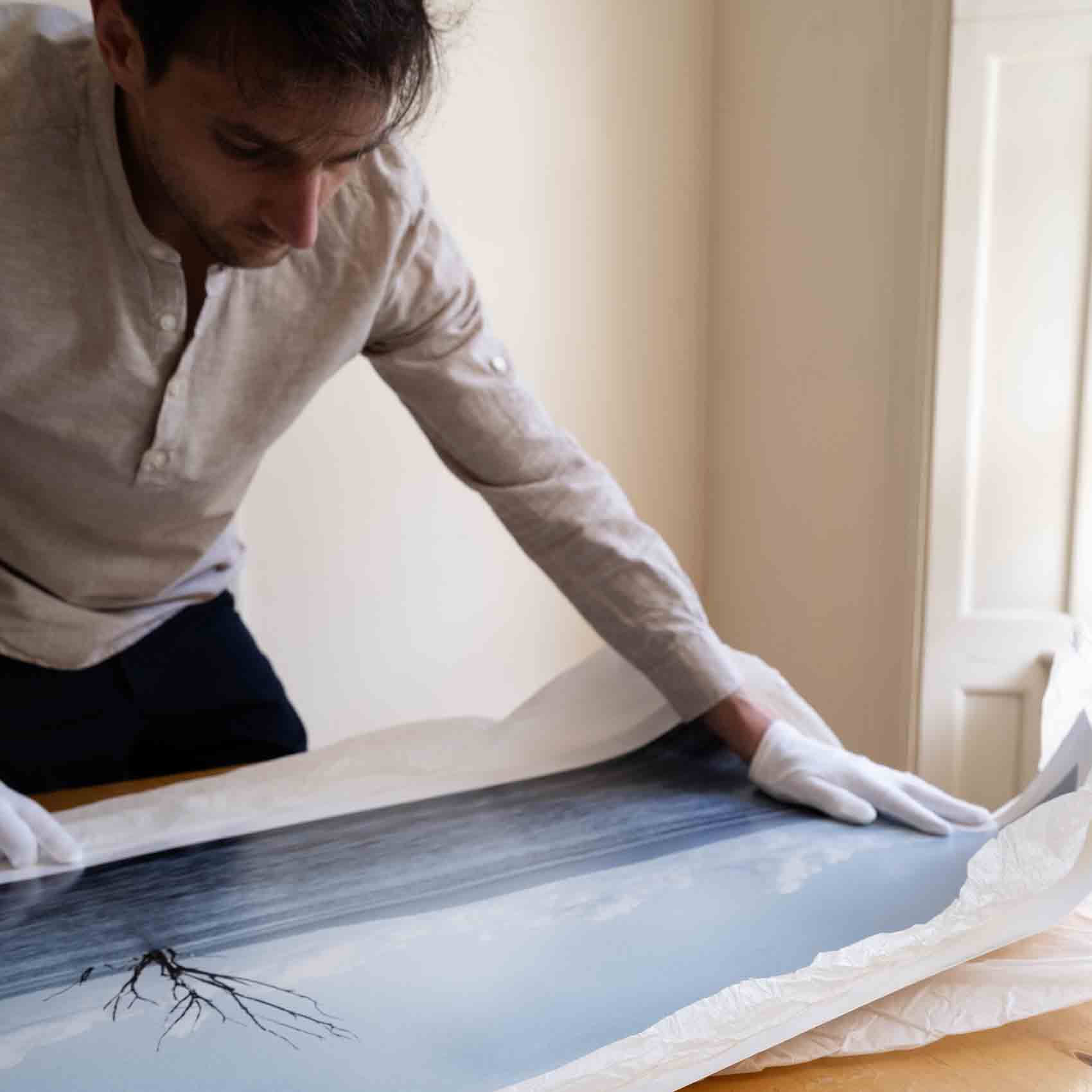 Photographer inspecting full print on a table