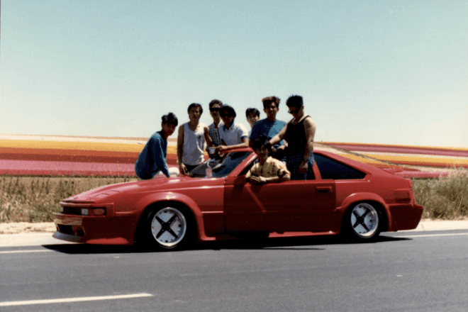 Old photo of the author's family with a car
