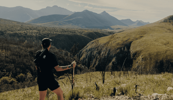 Johnny Wolf running towards the moutnains using rekking poles during the Tsitsikamma Ultra