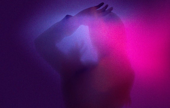 a person riding a snowboard on top of a sandy hill