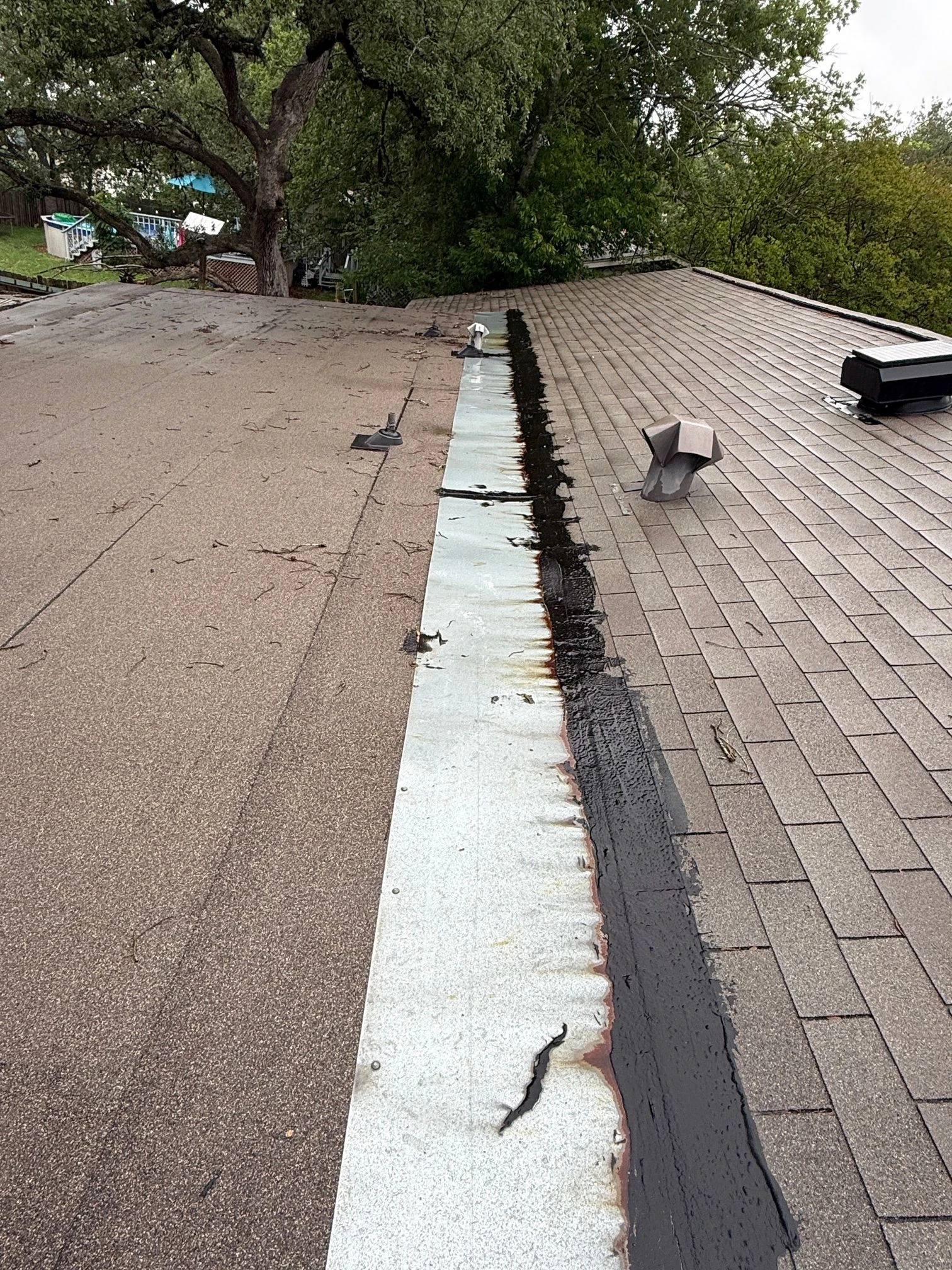 Before repair: shingle-to-flat-roof transition repair in Universal City, Texas.