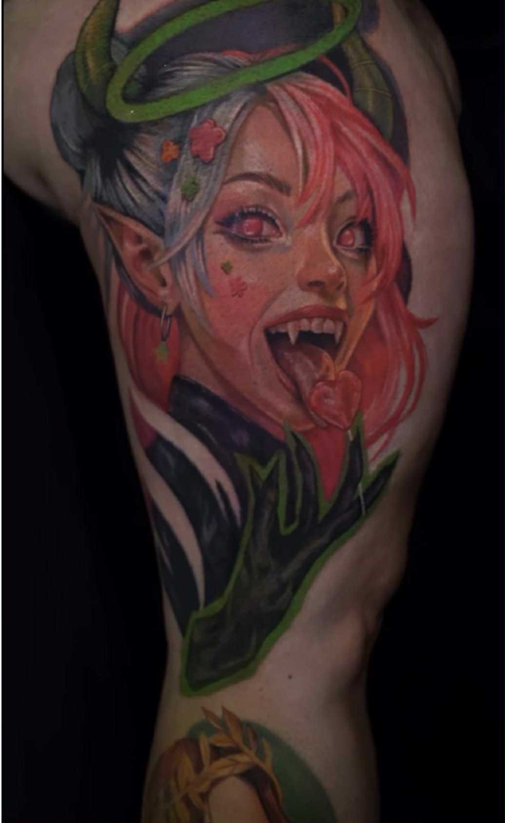 Winged figure tattoo with sun and geometric details.