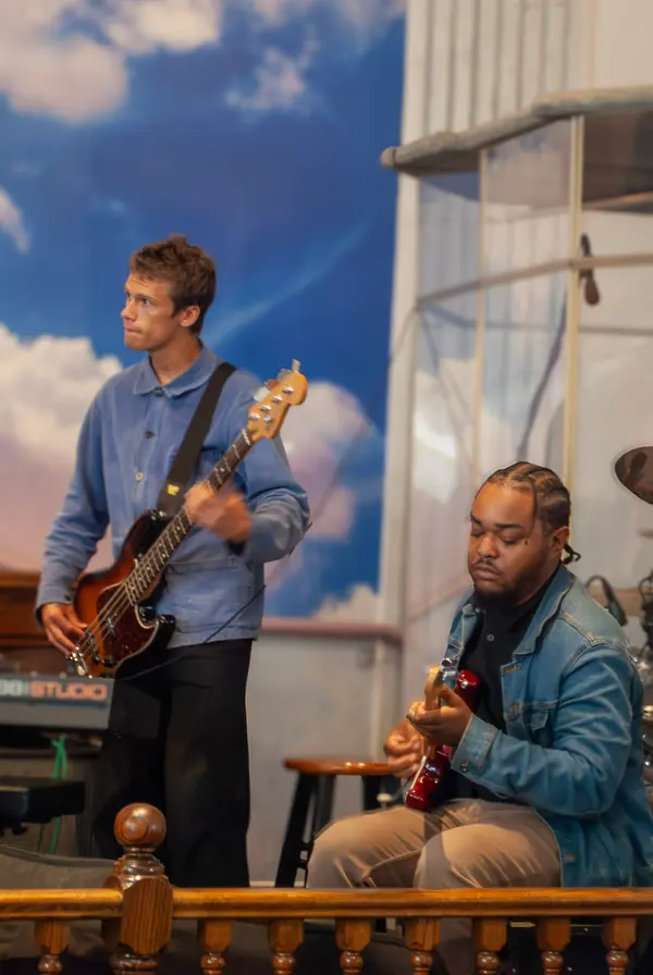 Church musicians playing guitar and bass during worship service