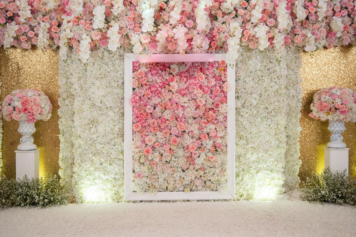 Vibrant floral photo wall with a colorful backdrop, perfect for a fun selfie station.