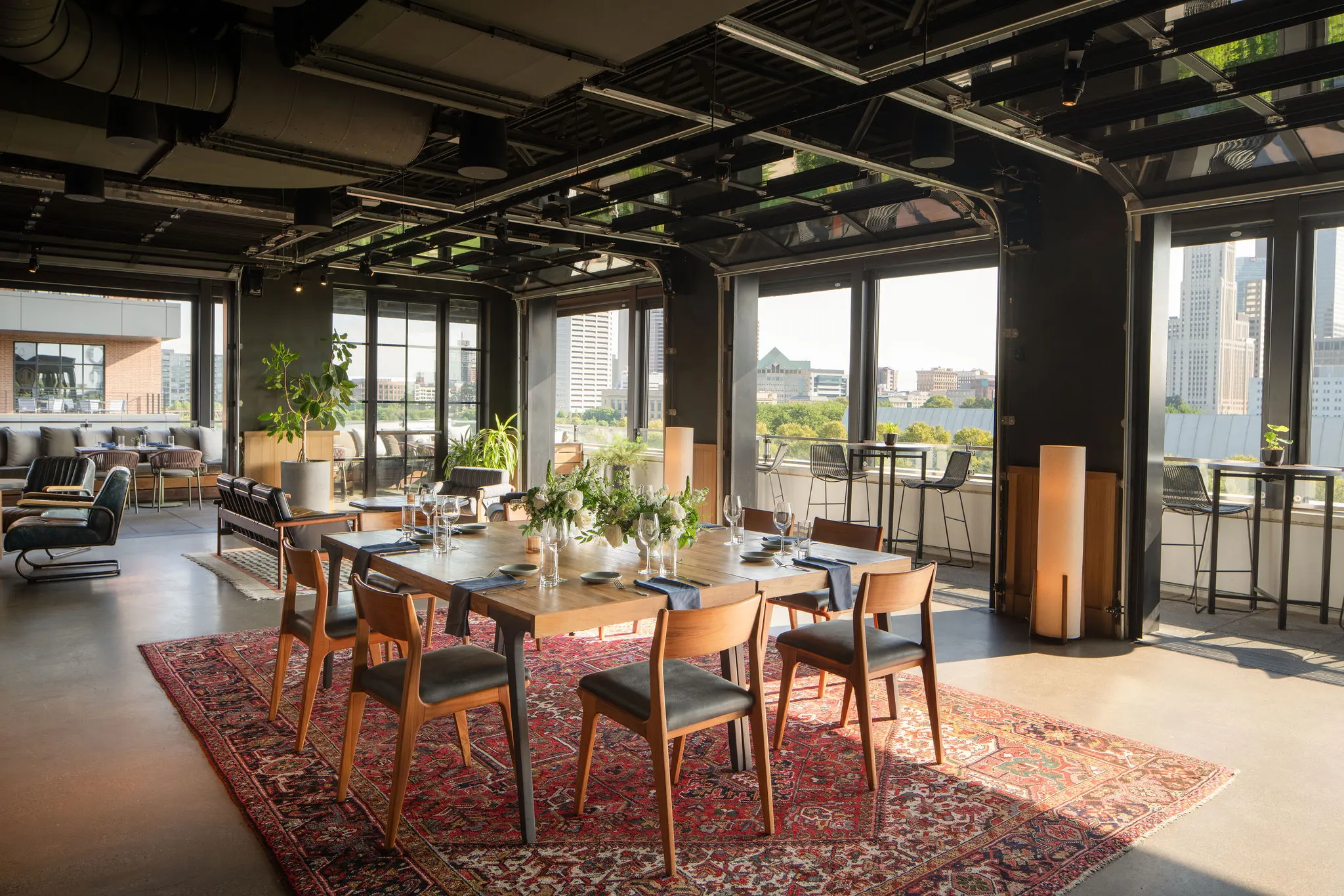 Brass Eye private dining room with a long table set for dinner and city views