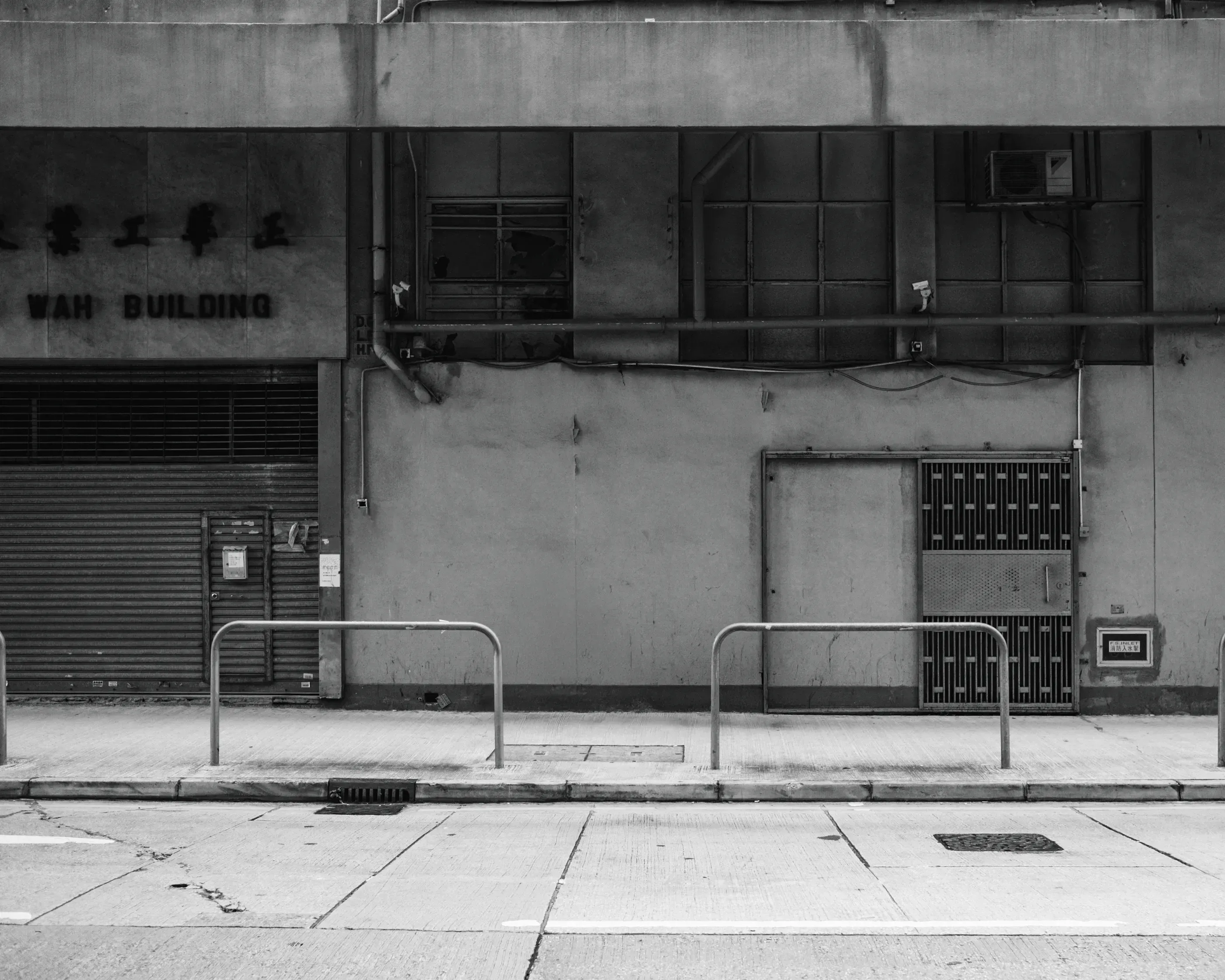 Teatime Studio hero visual – Hong Kong based freelance designer, textured old building with metal shutters in Wah Building, evoking everyday creativity and local roots.