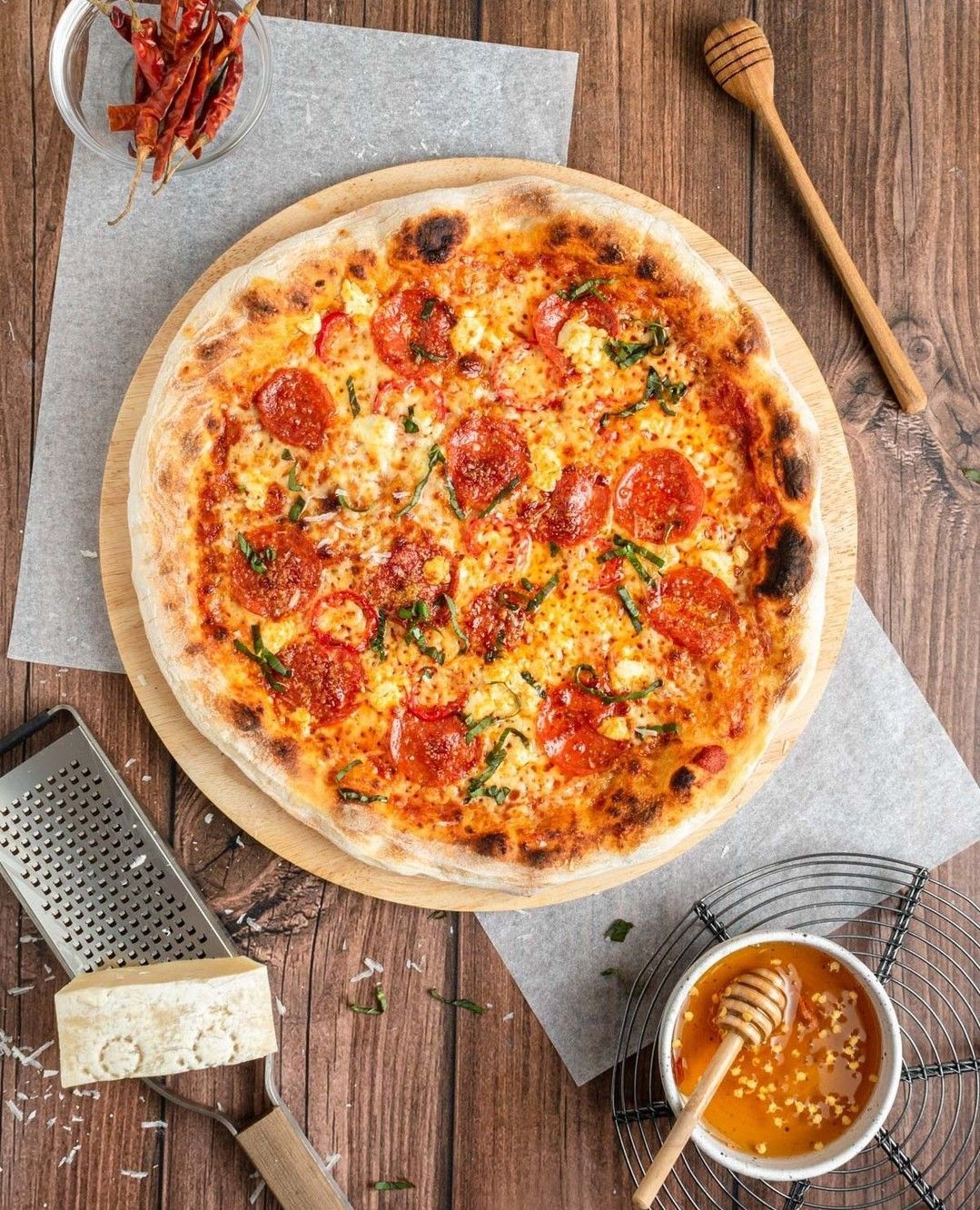 Honey Heat Pizza from Pasta 9 Toronto made with salami, pepperoni, chili flakes, and honey for a spicy-sweet combination.