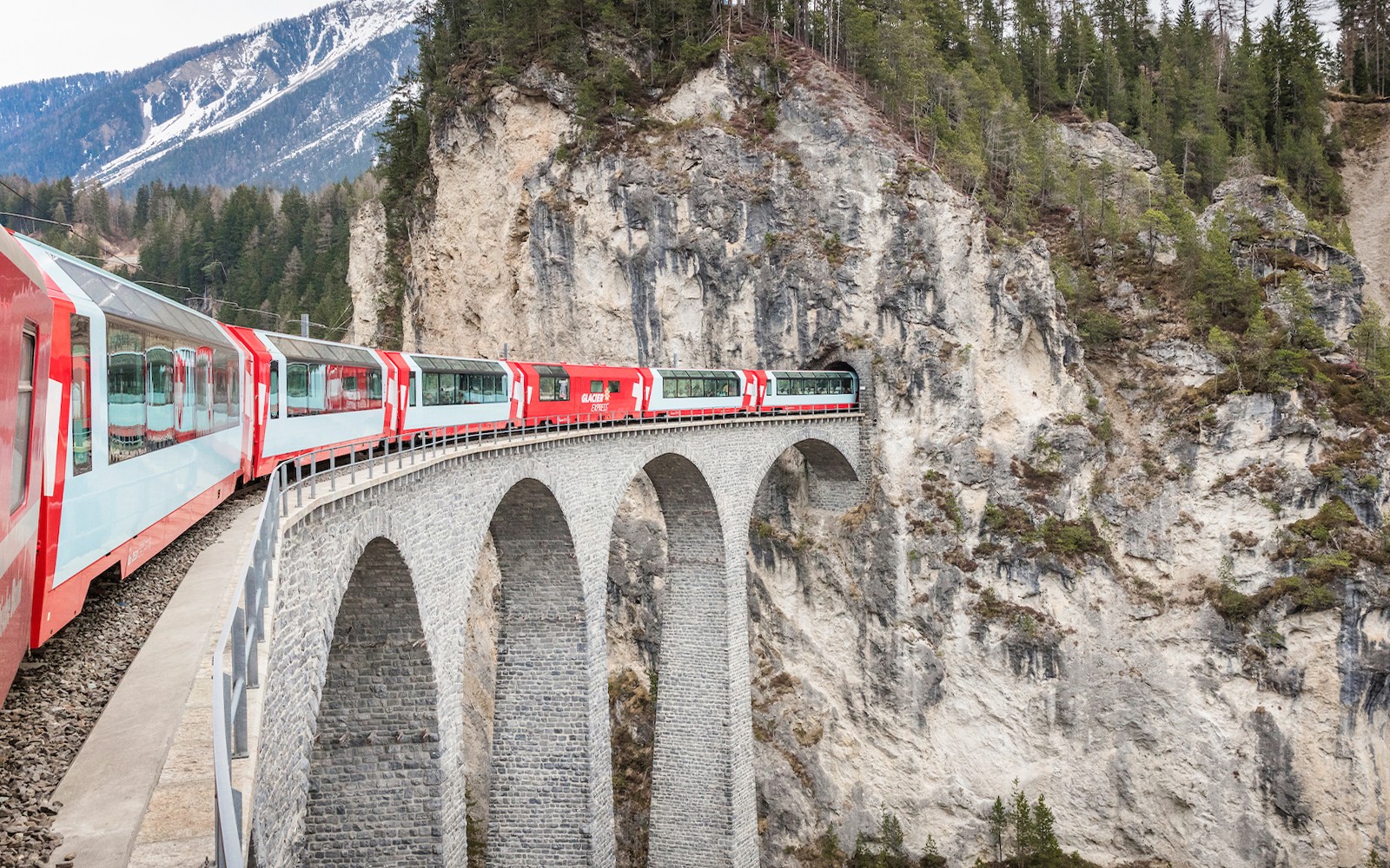 Train crossing Landwasser Viaduct in Swiss Alps.