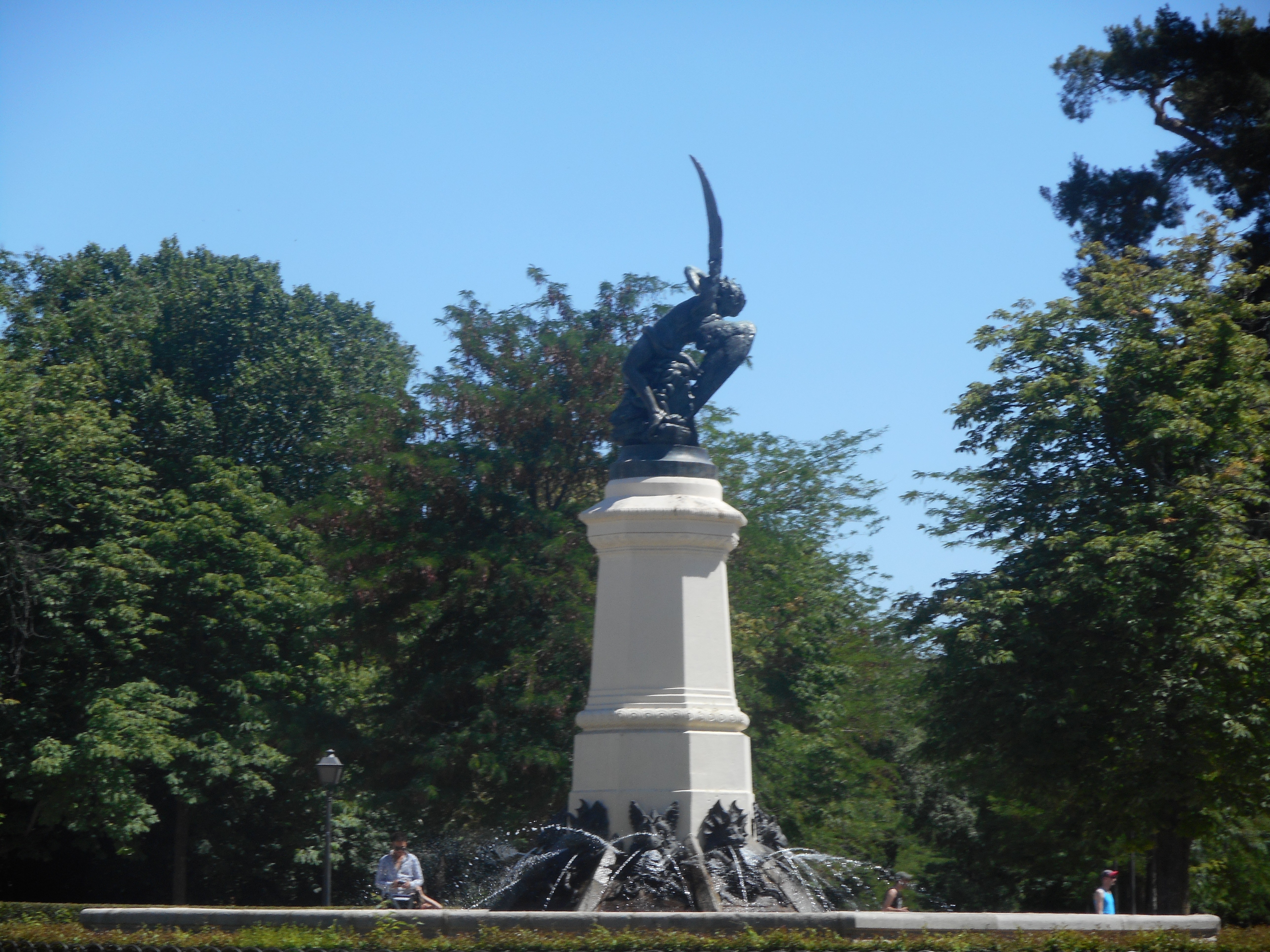 a woman sitting on a white chair next to a table