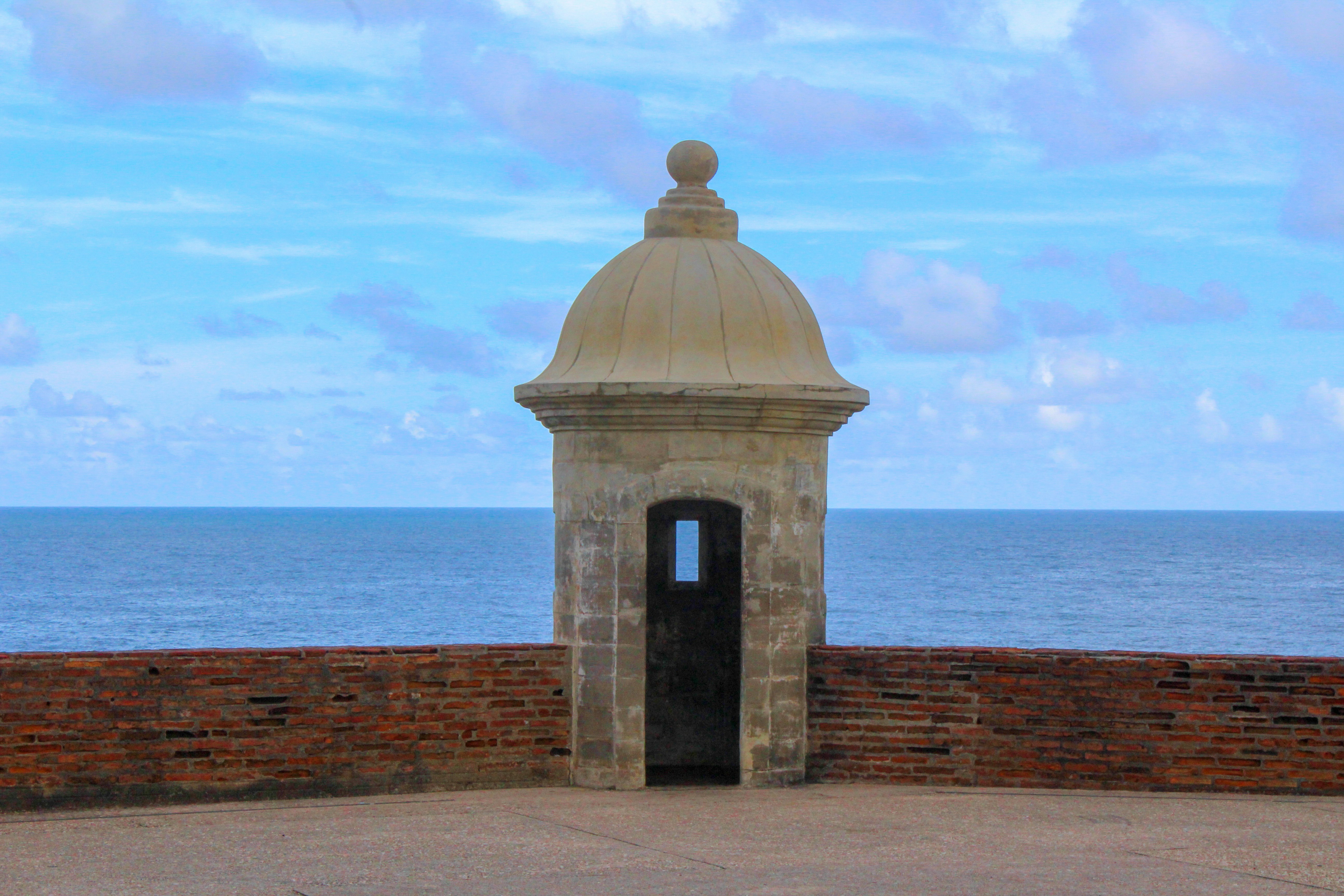 wide road with vehicle traveling with white dome building