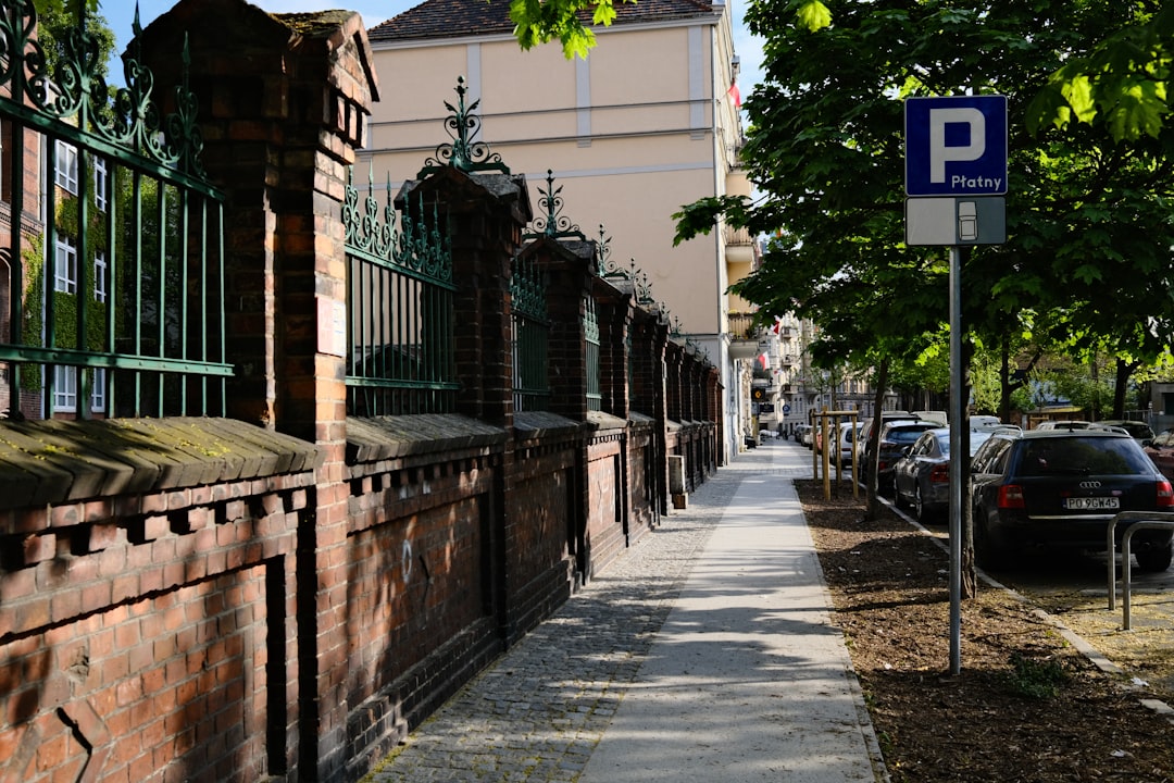 a sidewalk with cars parked on the side
