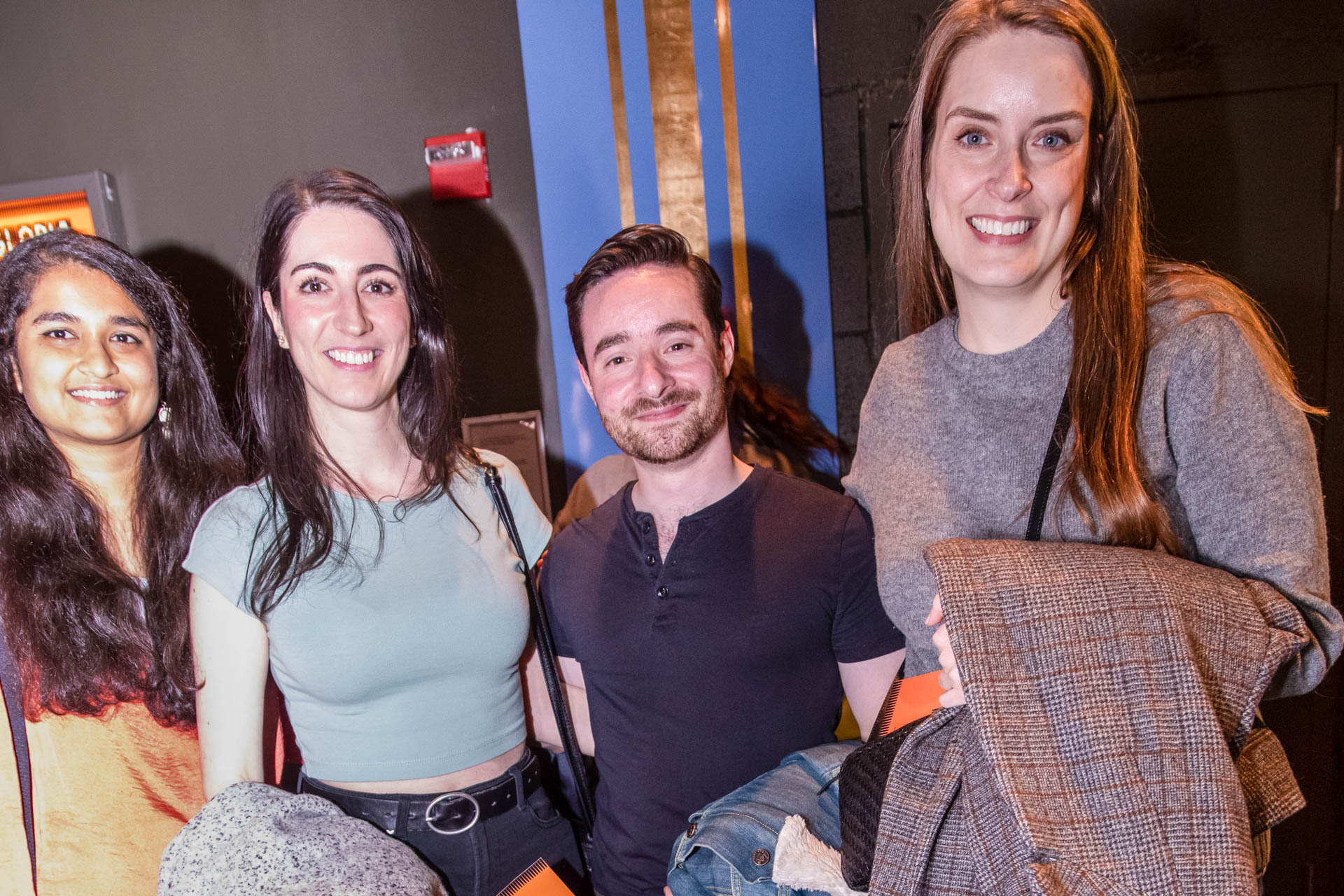 a group of students smiling for the camera in the SVA Theatre lobby after the Venture Forum
