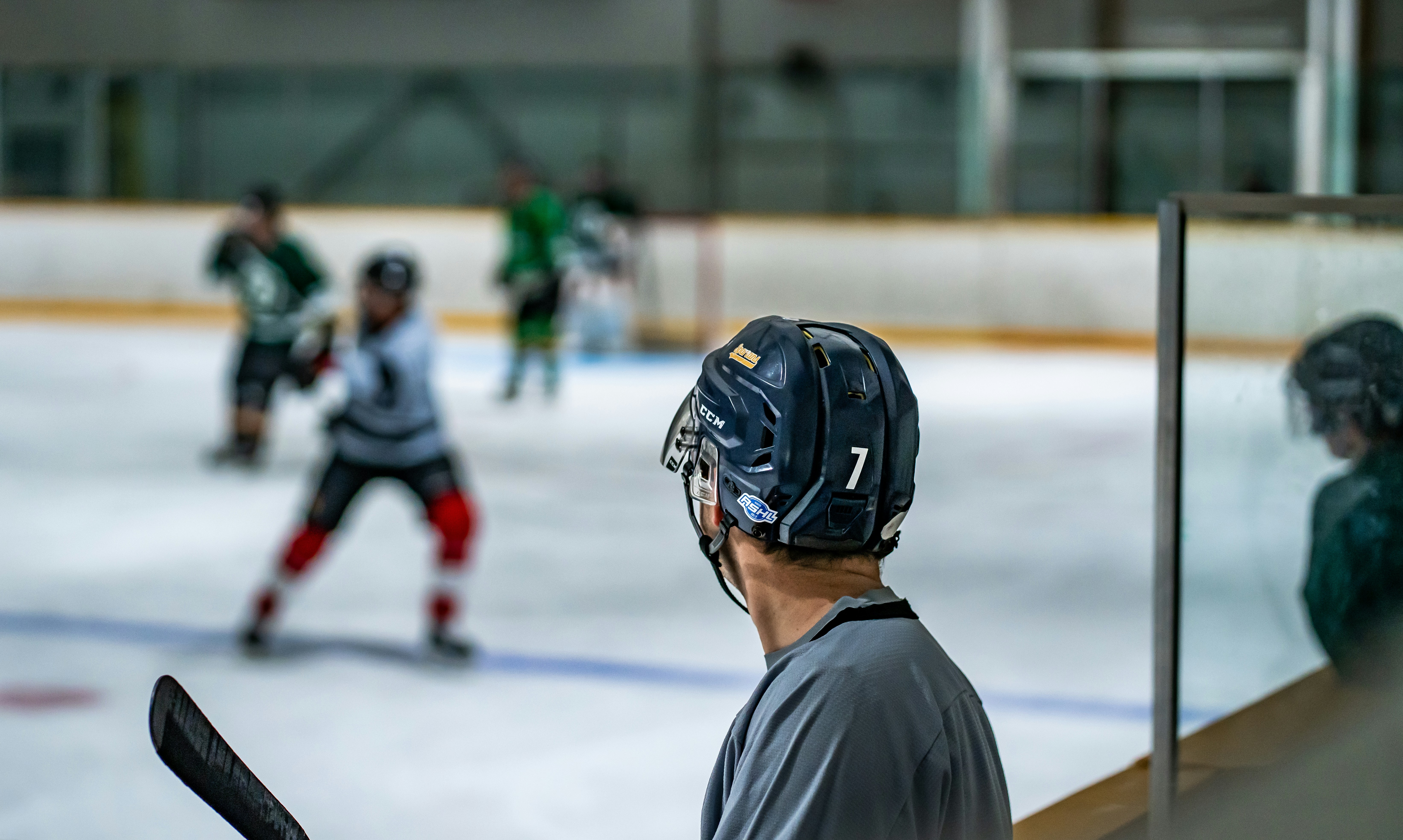 a group of young men playing a game of ice hockey