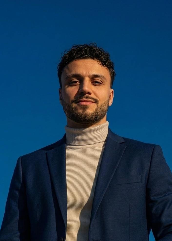 Woman wearing yellow turtleneck sweater.