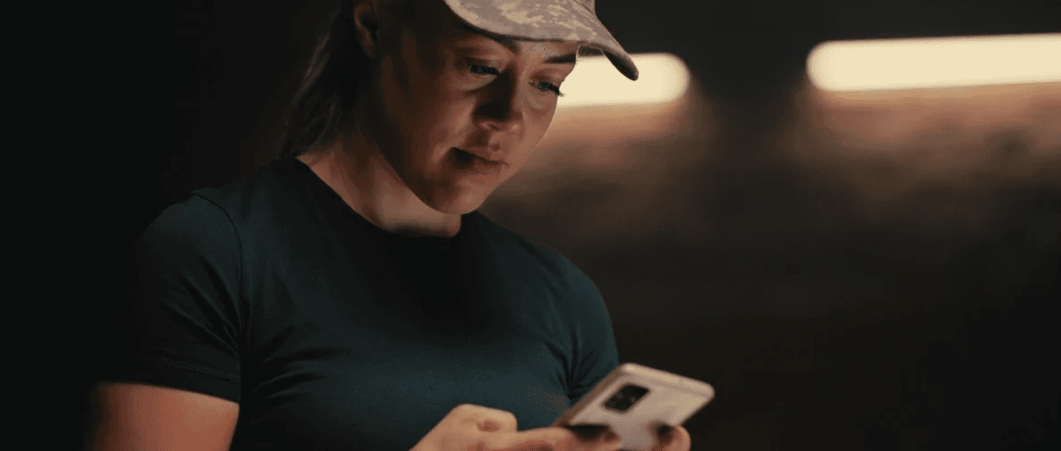 Focused individual in low light environment reflecting 