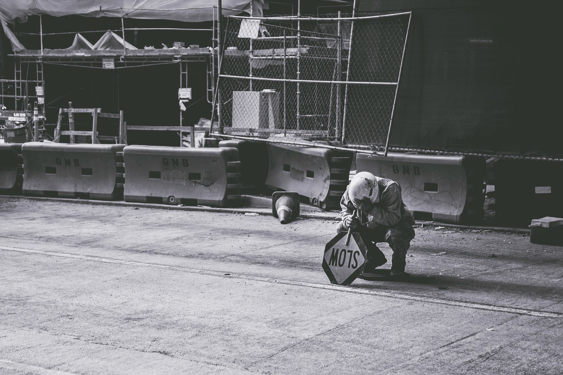 Tired construction worker courching to take a break