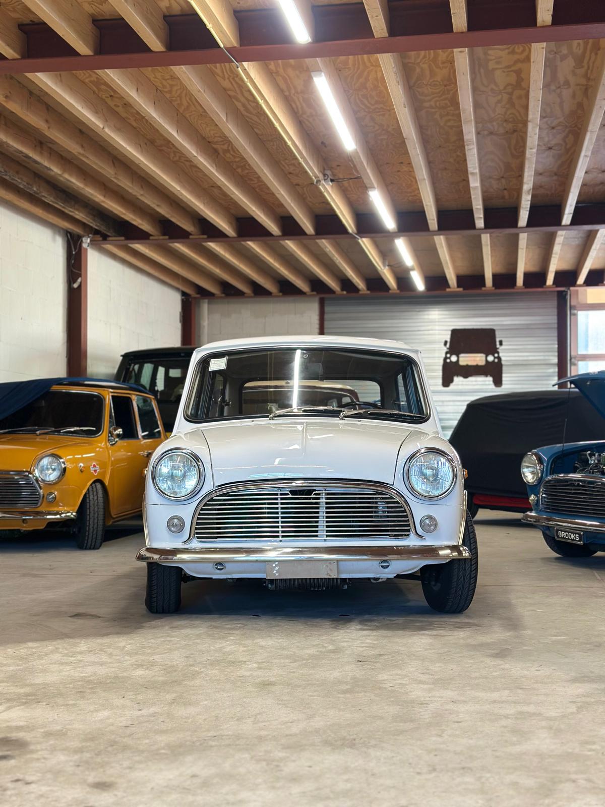 Pristine white mini classic car in a garage.