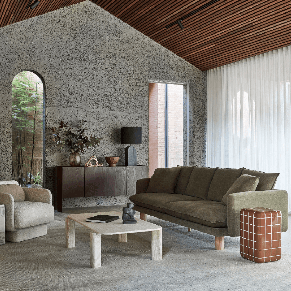 A green steep hill with skies in the background