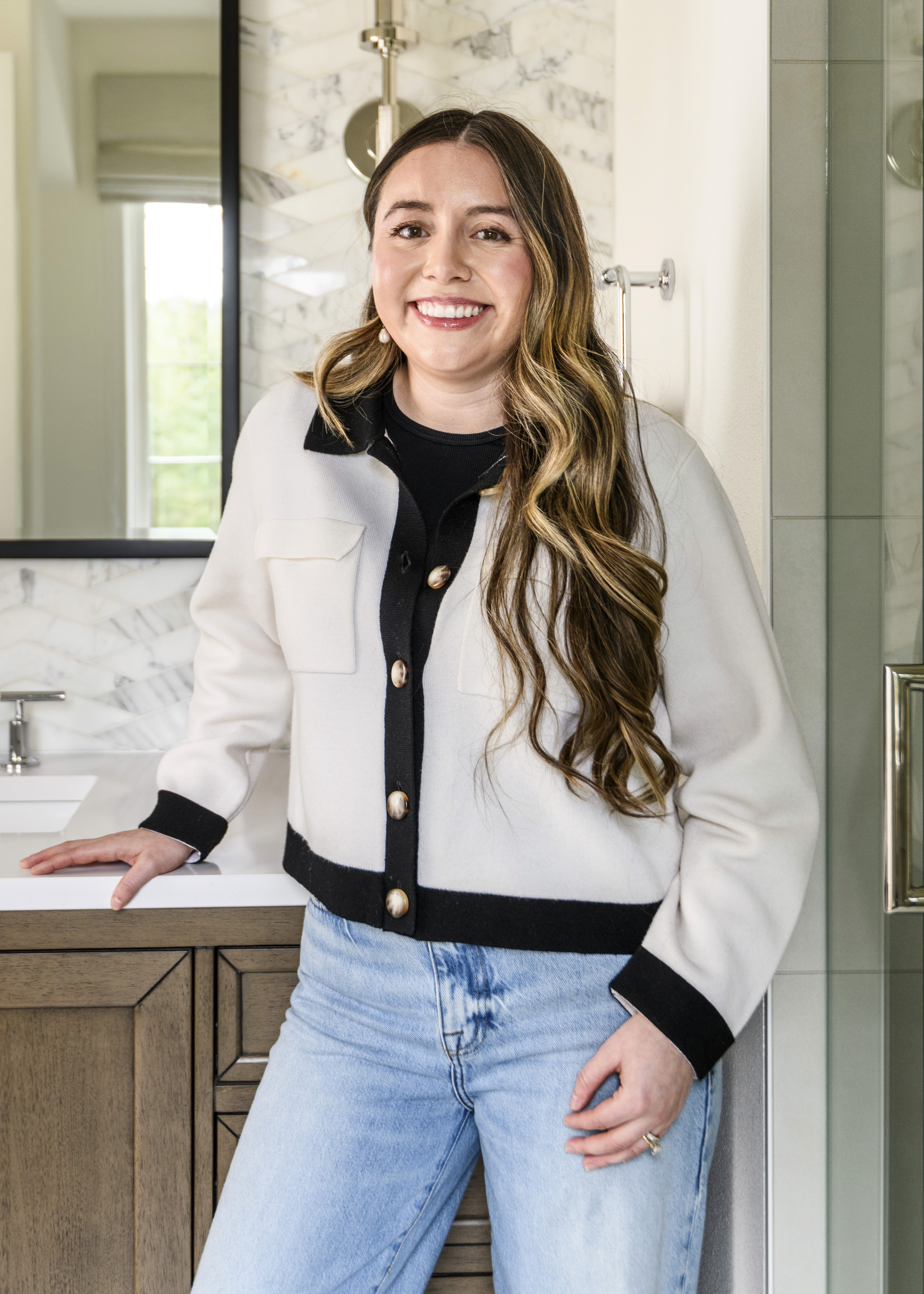 Elegant Simplicity team member arranges decor in this remodeled dining room in Issaquah WA by Elegant Simplicity Interior Design firm in Bellevue, WA