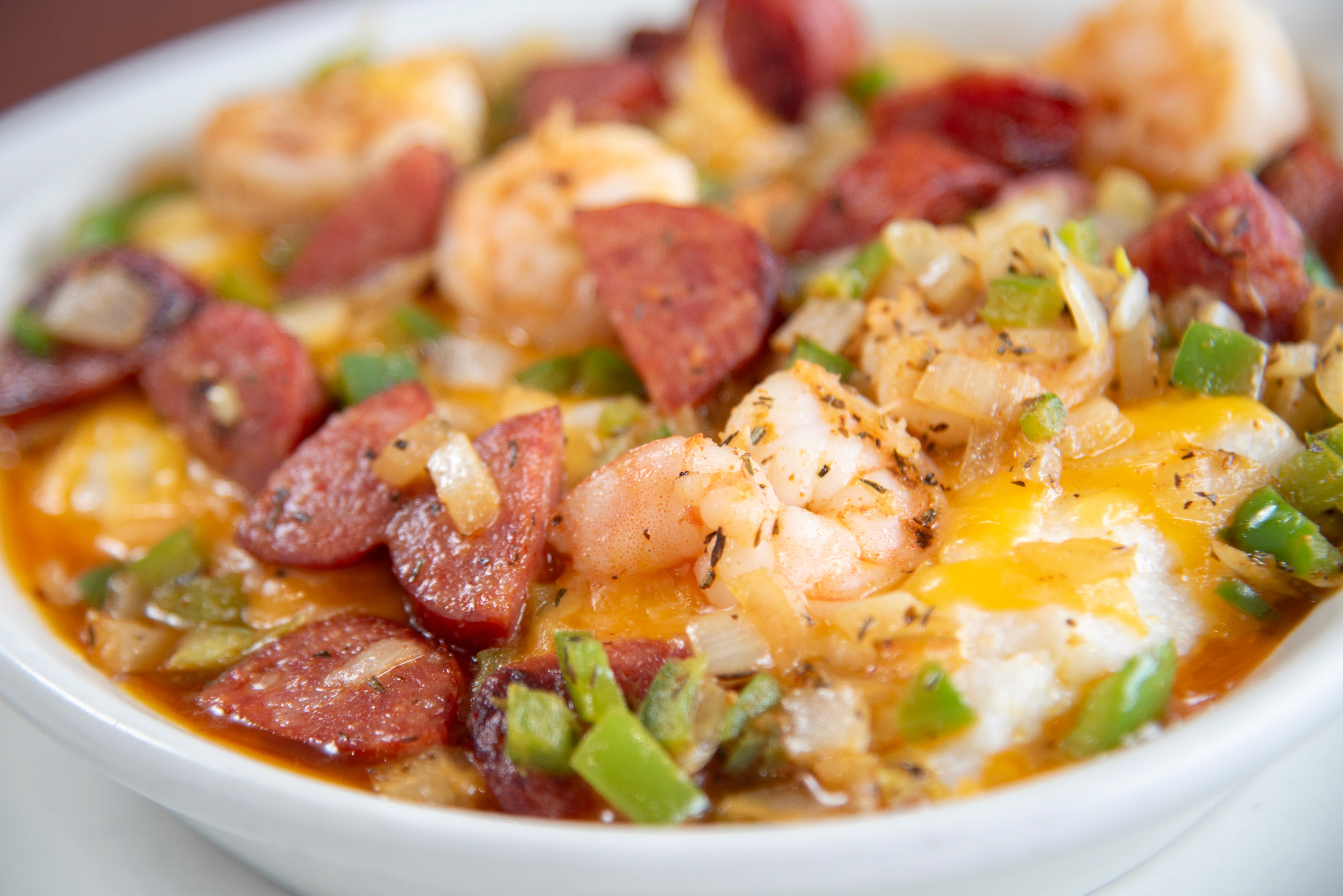 bread and bacon platter beside French press