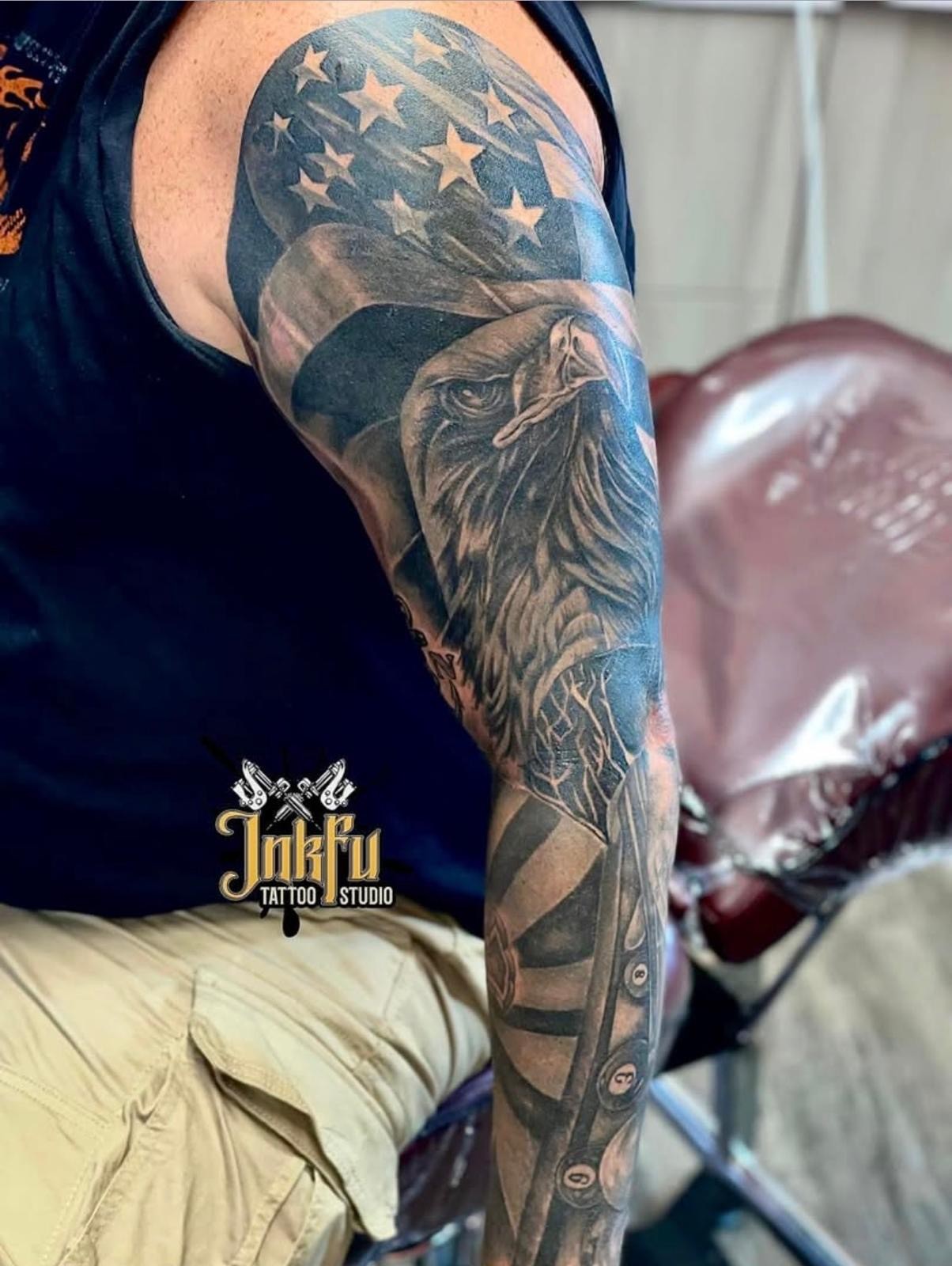 Black and grey American flag and eagle sleeve tattoo with pool balls on the forearm, by Meer Rich