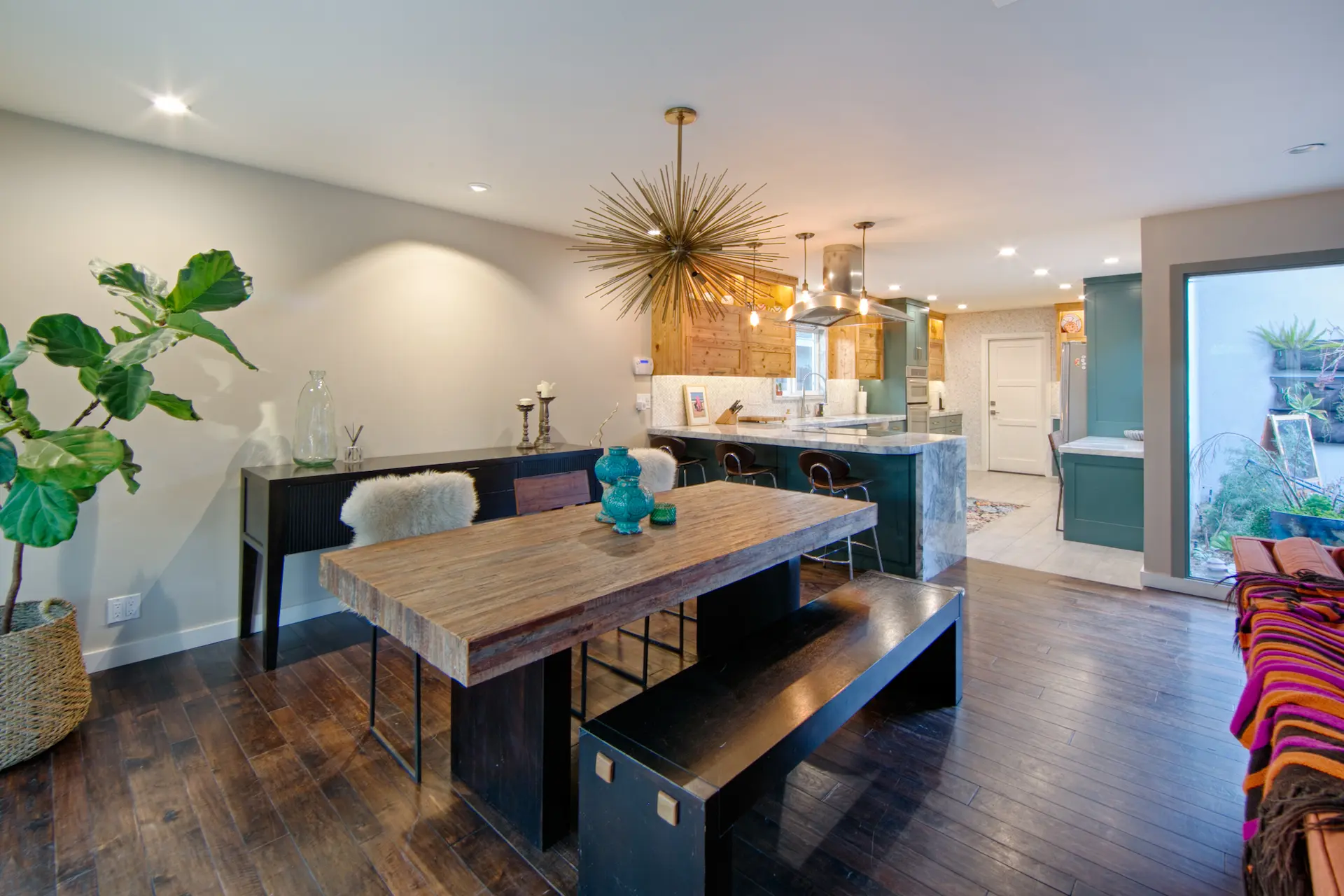 Dining area with modern table, bench seating, and view into kitchen in Huntington Beach Kitchen & Bath Remodel.