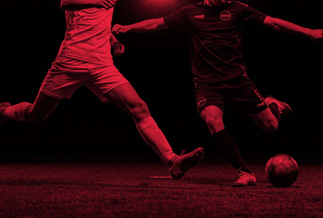 group of people playing soccer on field during daytime