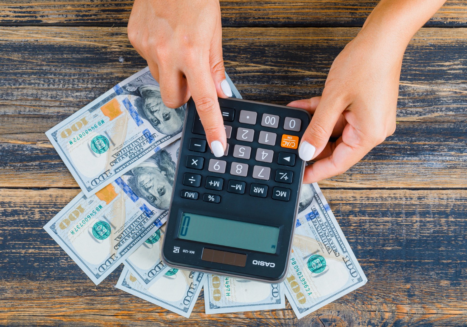 woman using a calculator - Loosely Structured Data Business Example