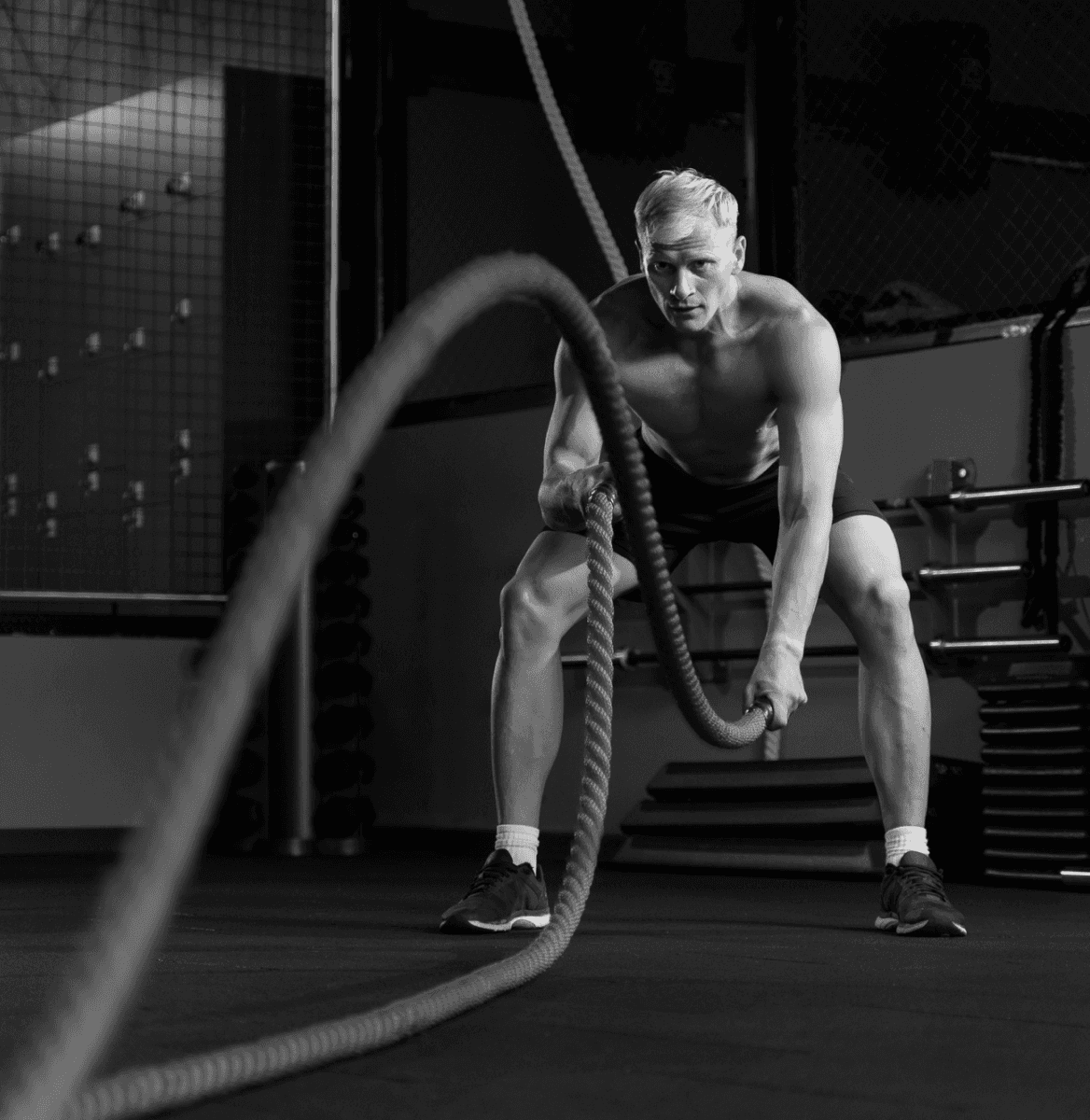 Man doing TRX suspension training in gym