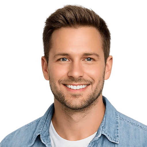Portrait of a smiling man wearing a light-colored shirt against a neutral background.